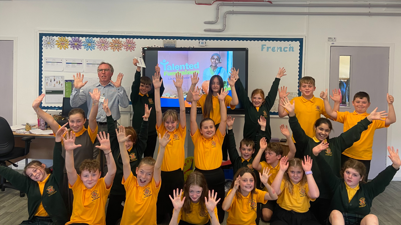 School kids waving their hands