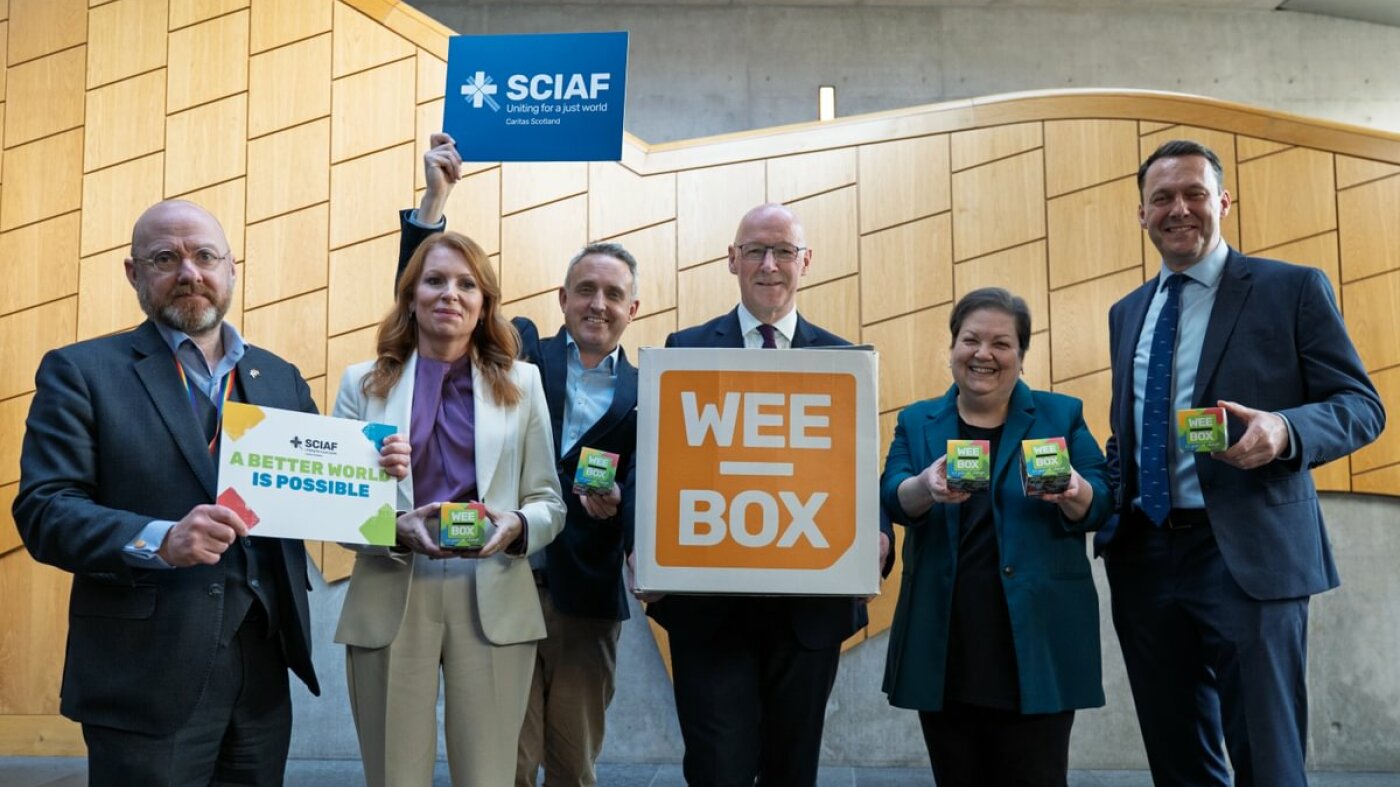 MSP's standing together in Holyrood with WEE BOX signs